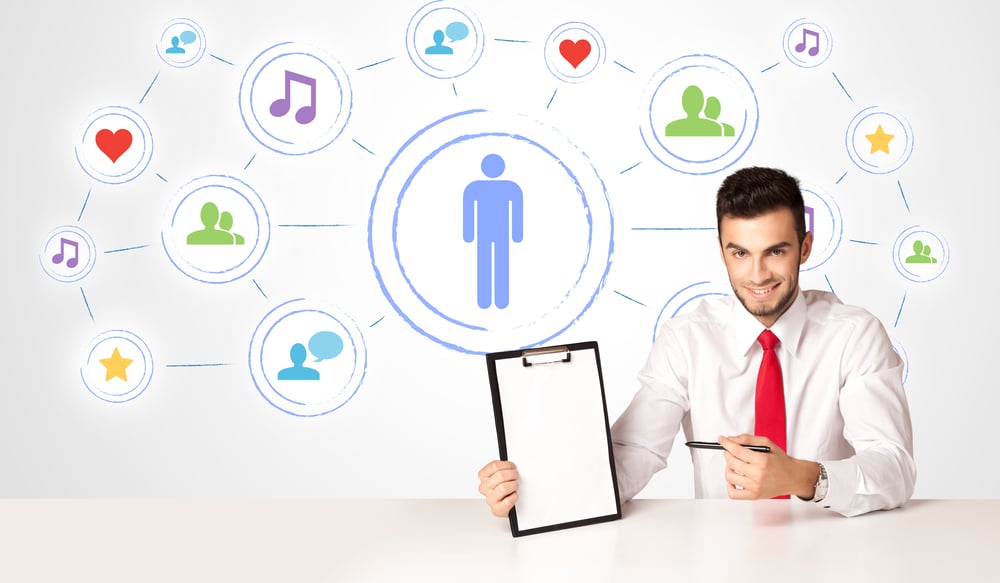 Businessman sitting at white table with social media connection background